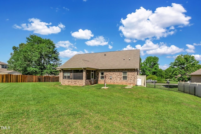 back of property with a lawn