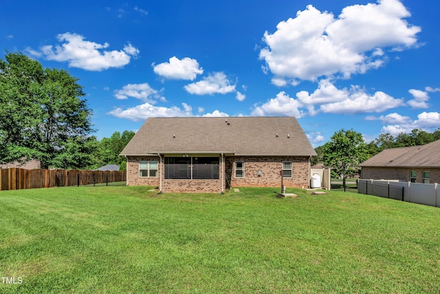 back of house featuring a yard