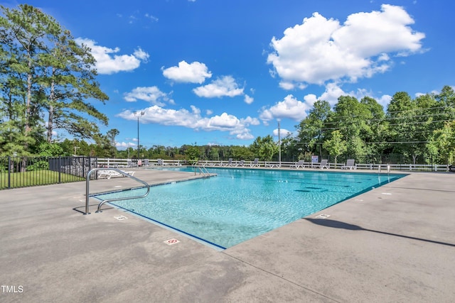 view of swimming pool featuring a patio area