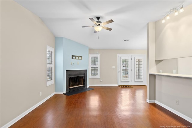 unfurnished living room with ceiling fan and dark hardwood / wood-style floors