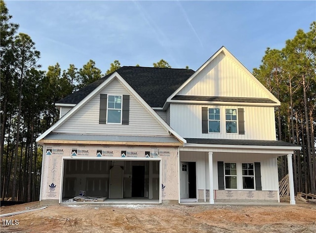 view of front of home featuring a porch and a garage