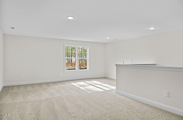 spare room with light colored carpet