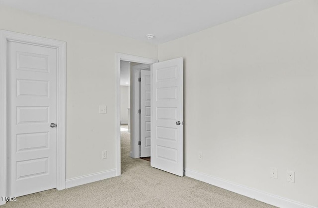 unfurnished bedroom with light carpet