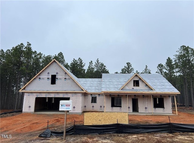 property under construction with an outbuilding, a porch, and a garage