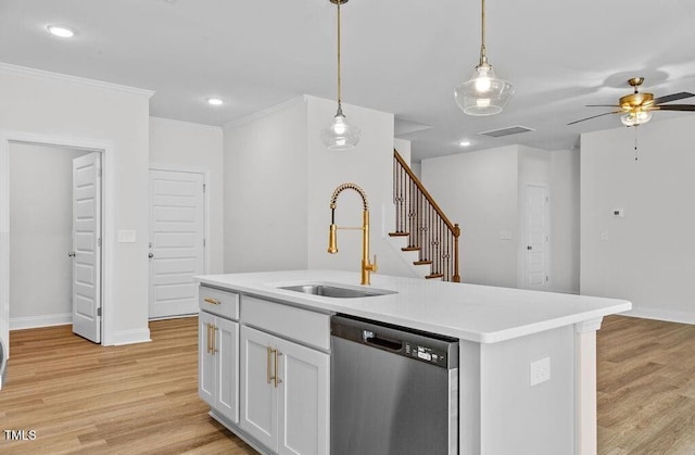 kitchen featuring white cabinetry, dishwasher, sink, hanging light fixtures, and an island with sink