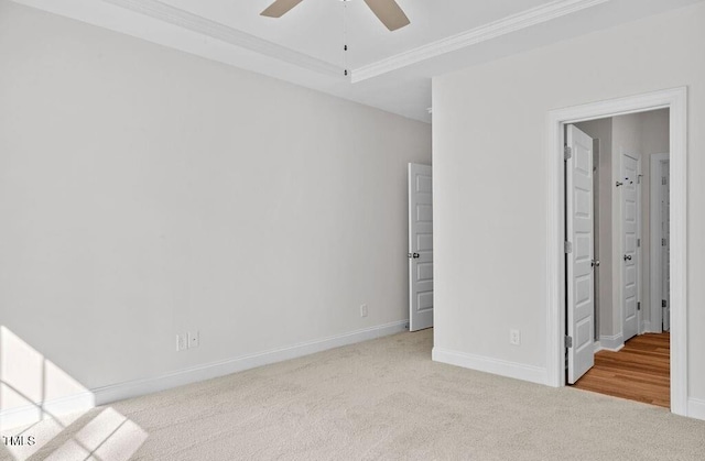 unfurnished room with ceiling fan, crown molding, and light carpet