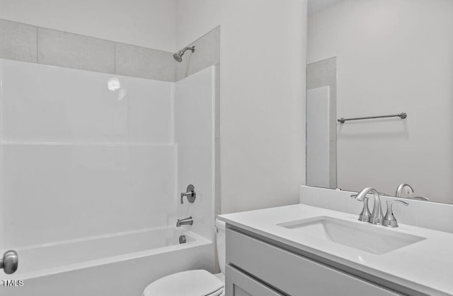 full bathroom featuring vanity, toilet, and washtub / shower combination