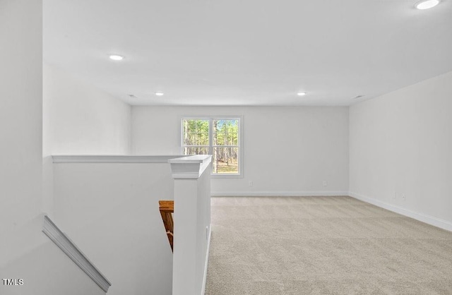 unfurnished room featuring light carpet