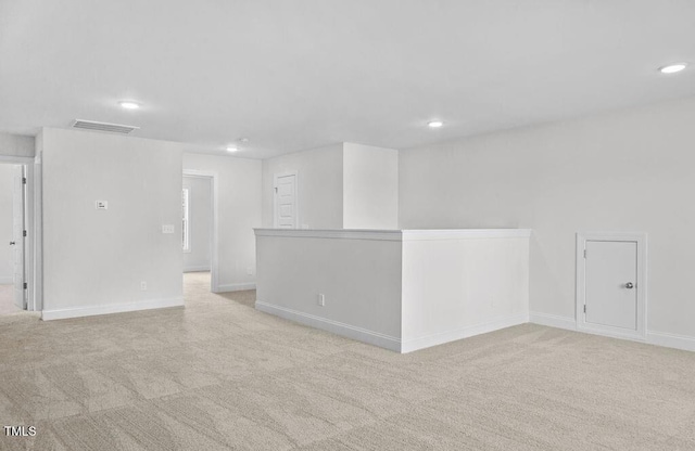 unfurnished room featuring light carpet