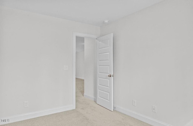 unfurnished room with light colored carpet