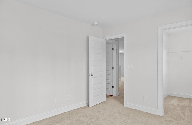 unfurnished bedroom featuring light carpet