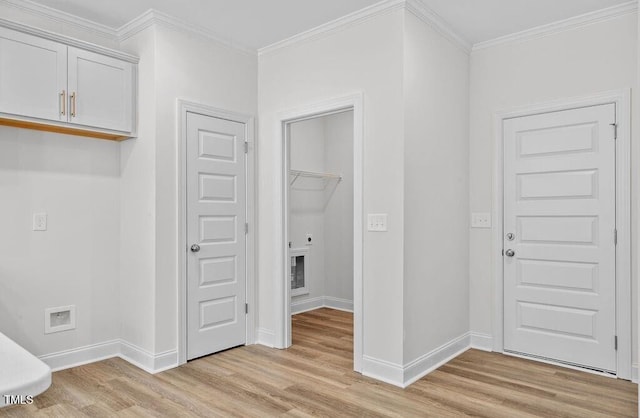 washroom with light hardwood / wood-style floors and ornamental molding