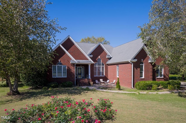 view of front of house featuring a front yard and a patio