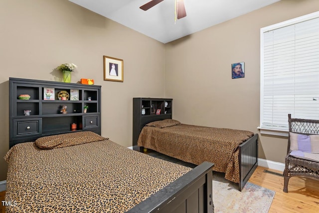 bedroom with ceiling fan and light hardwood / wood-style floors