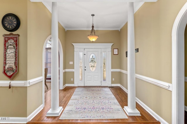 entryway with hardwood / wood-style flooring and ornamental molding