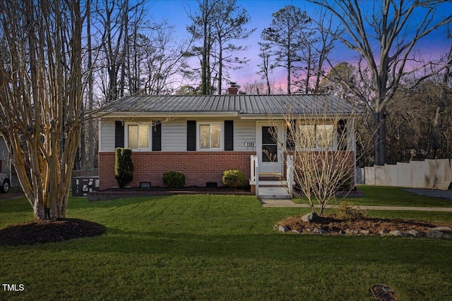 ranch-style home featuring a yard