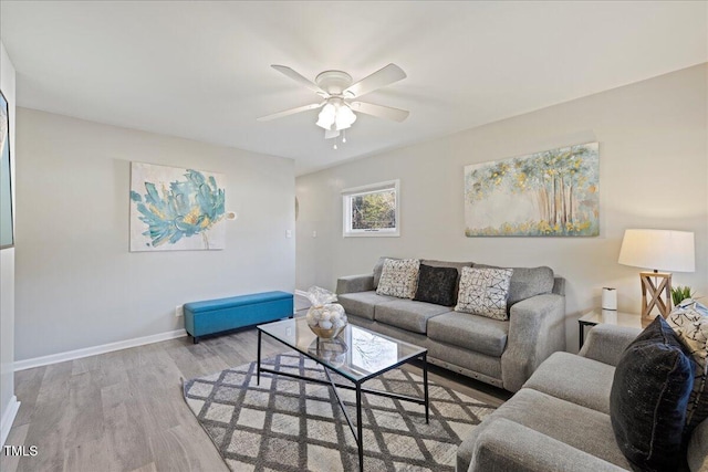 living room featuring ceiling fan and light hardwood / wood-style floors