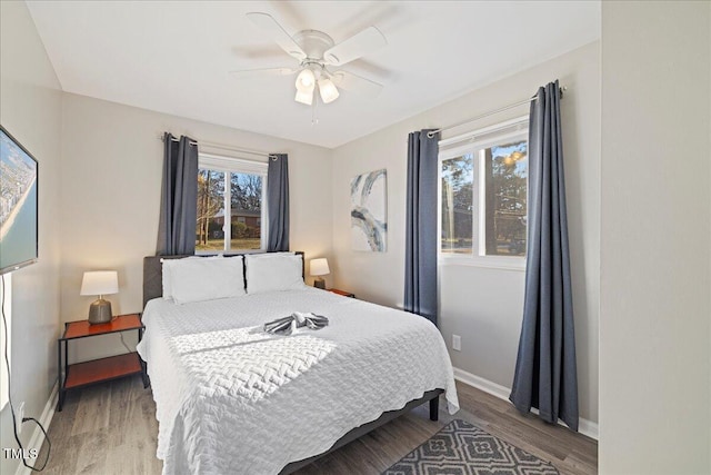 bedroom with ceiling fan and hardwood / wood-style flooring