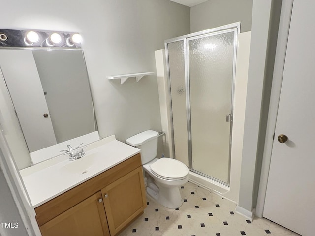 bathroom with vanity, toilet, and an enclosed shower