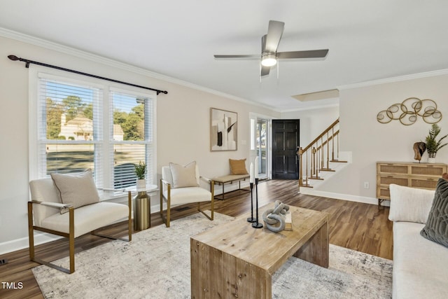 living room featuring hardwood / wood-style flooring, ceiling fan, and ornamental molding