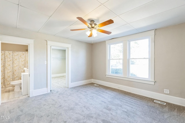 carpeted spare room with ceiling fan