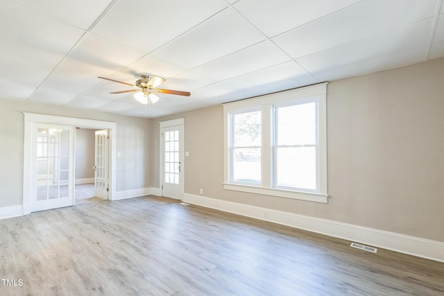 unfurnished room featuring ceiling fan, light hardwood / wood-style floors, and french doors