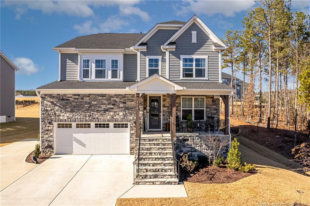 craftsman-style house featuring covered porch and a garage