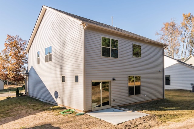 back of property featuring a yard and a patio