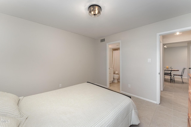 tiled bedroom featuring ensuite bathroom