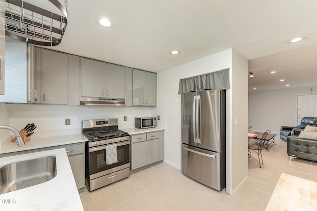 kitchen featuring light tile patterned floors, appliances with stainless steel finishes, sink, and gray cabinets