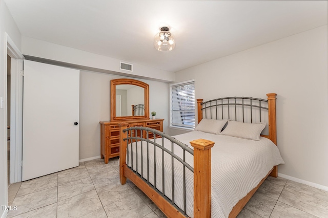 bedroom with light tile patterned flooring