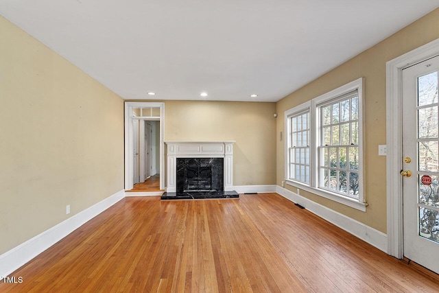 unfurnished living room with light hardwood / wood-style flooring and a fireplace