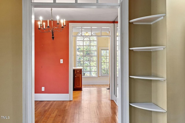 interior space with an inviting chandelier and light wood-type flooring