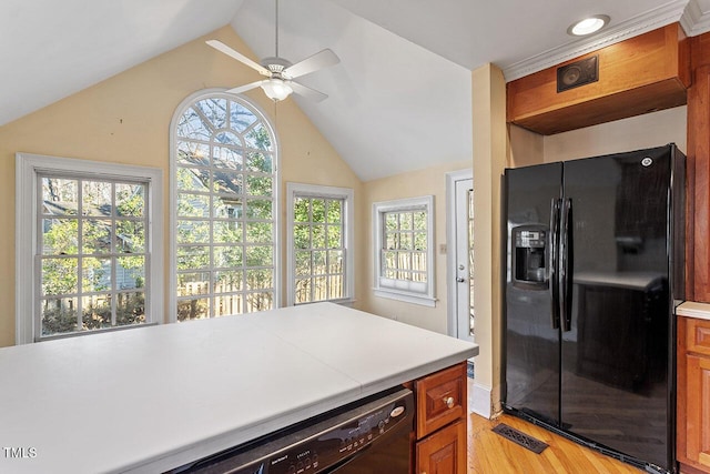 kitchen with light hardwood / wood-style flooring, black appliances, ceiling fan, and vaulted ceiling