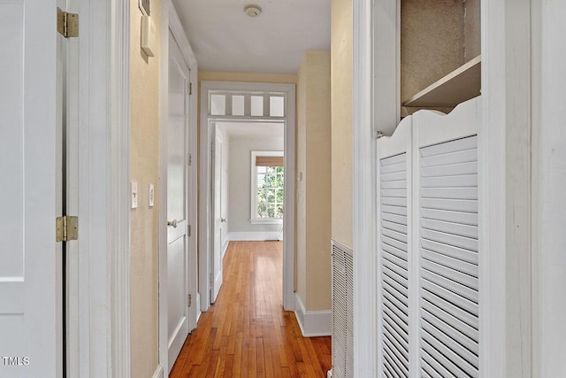 corridor with hardwood / wood-style flooring