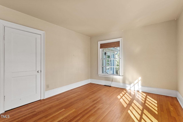 empty room with hardwood / wood-style flooring