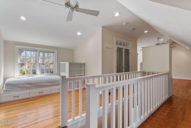 corridor featuring hardwood / wood-style flooring and lofted ceiling