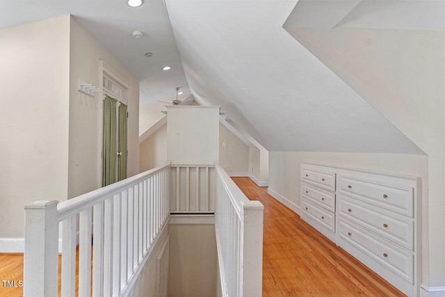 interior space featuring lofted ceiling and light hardwood / wood-style flooring