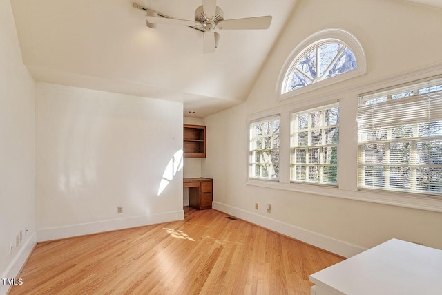 living room with high vaulted ceiling, ceiling fan, and light hardwood / wood-style flooring