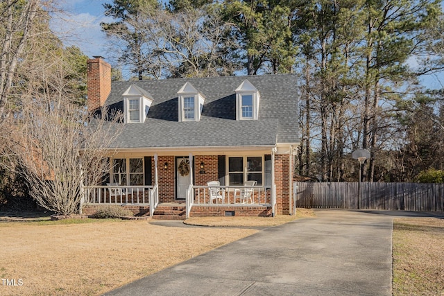 new england style home with covered porch