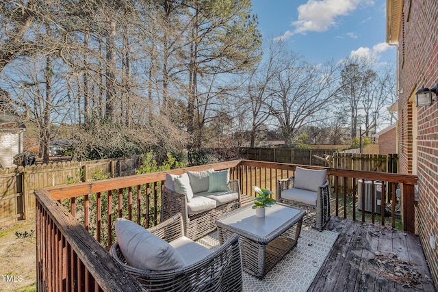 wooden deck featuring central AC unit and an outdoor hangout area