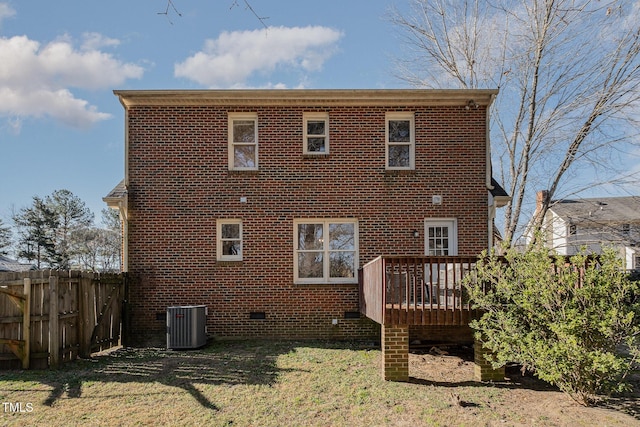 back of property with central AC unit, a lawn, and a wooden deck