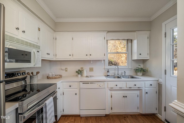 kitchen with white appliances, white cabinets, light wood-type flooring, and sink