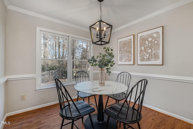 dining area with dark hardwood / wood-style flooring, a chandelier, crown molding, and a healthy amount of sunlight