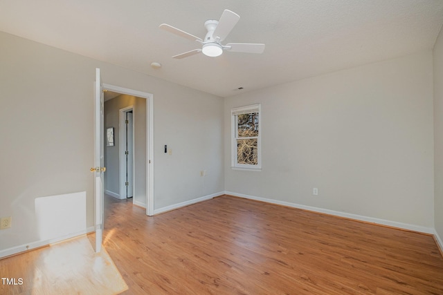 spare room featuring ceiling fan and light hardwood / wood-style floors