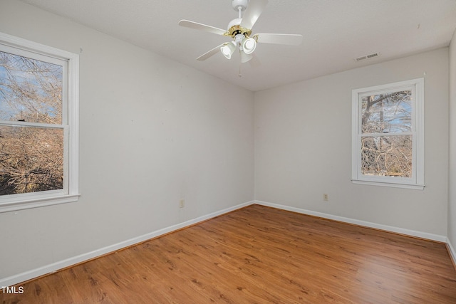 unfurnished room with ceiling fan and wood-type flooring