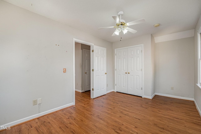 unfurnished bedroom featuring a closet, ceiling fan, and hardwood / wood-style flooring