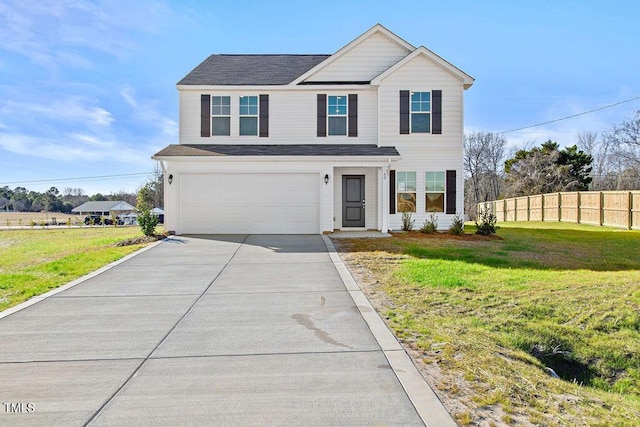 view of property featuring a front yard and a garage