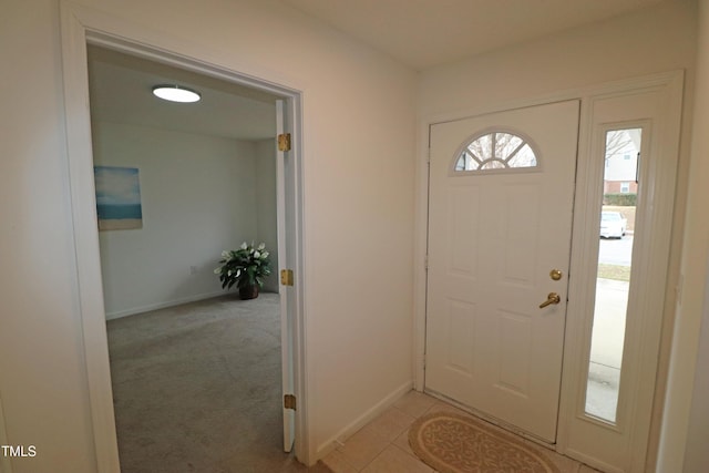 entrance foyer featuring light colored carpet