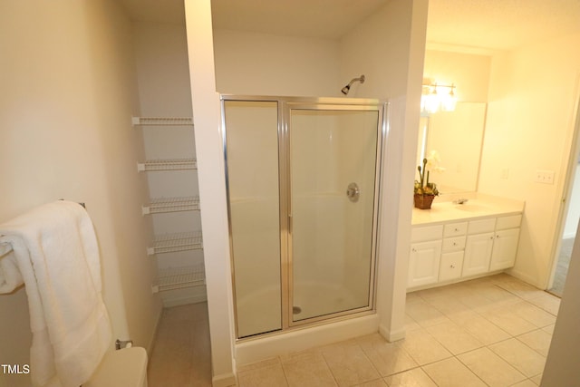 bathroom featuring vanity, tile patterned floors, and a shower with door